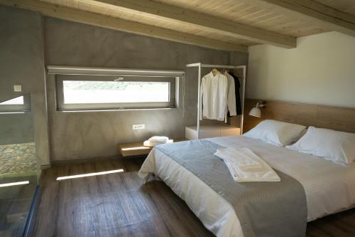 埃亚玛琳娜奈奇多Iskios Villas的一间卧室设有一张大床和一个窗户。