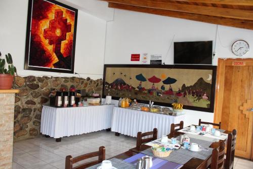 奥兰太坦波提拉加圣谷酒店的餐厅设有2张桌子和1个带葡萄酒瓶的吧台