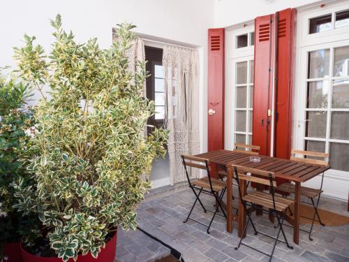 阿卡雄CAP BERILOU . Qualité et Confort Assuré .的庭院设有木桌、椅子和植物