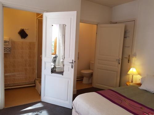 Jumeaux环岛酒店的一间卧室配有一张床,浴室设有卫生间