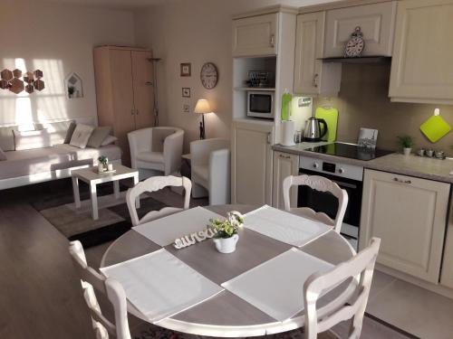 梅斯Chic En Ville的厨房以及带桌椅的起居室。