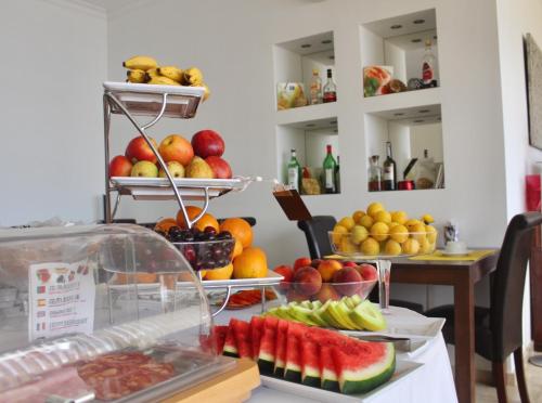 蒙蒂戈杜洛萨琳达酒店的盘子上摆放着水果和蔬菜的桌子