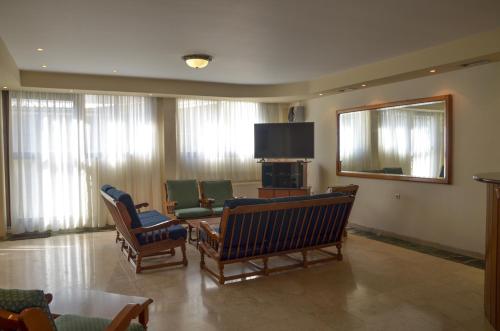 普托莱迈达Hotel Costis的客厅配有椅子和平面电视