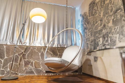 科隆18Arts Hotel - Living in a Gallery!的一个带灯的房间的摆椅