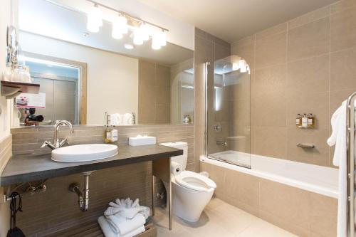 悉尼悉尼码头温泉酒店 的浴室配有盥洗盆、卫生间和浴缸。