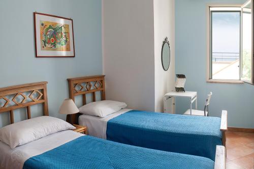 圣凯撒利亚温泉Fico d'India的一间卧室设有两张床和窗户。