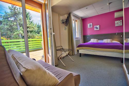 多勒Logis Hôtel Restaurant Le Chalet du Mont Roland的一间卧室配有一张床和紫色的墙壁
