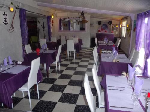尼姆灌木丛旅馆的餐厅设有紫色桌椅和 ⁇ 制地板