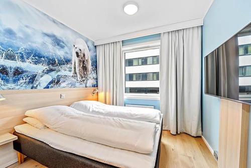 特罗姆瑟泼乐松恩酒店的一间卧室配有一张床和一台电视。