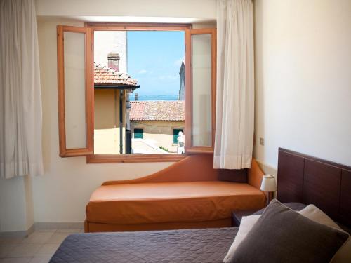 奥尔贝泰洛Hotel Sole的一间卧室设有一张床和一个美景窗户。