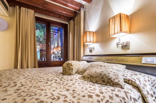 威尼斯卡代多奇旅馆的一间卧室设有一张床和一个窗口