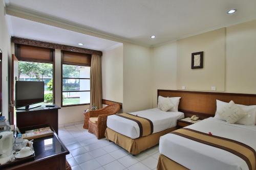 The Jayakarta Bali Beach Resort客房内的一张或多张床位