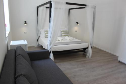 锡拉库扎Dimora di Artemide的带沙发和天蓬床的客厅