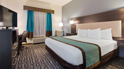 Waldo沃尔多贝斯特韦斯特套房酒店的配有一张床和一台平面电视的酒店客房