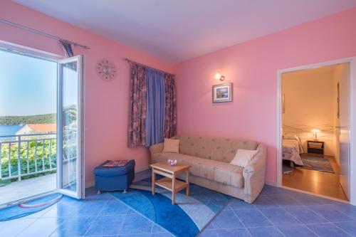 莫鲁纳特Apartments Saulan的客厅设有粉红色的墙壁和沙发