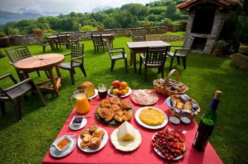 Ziga卡萨乡村兹盖克艾特克斯兹日酒店的红色的桌子上摆放着食物和一瓶葡萄酒