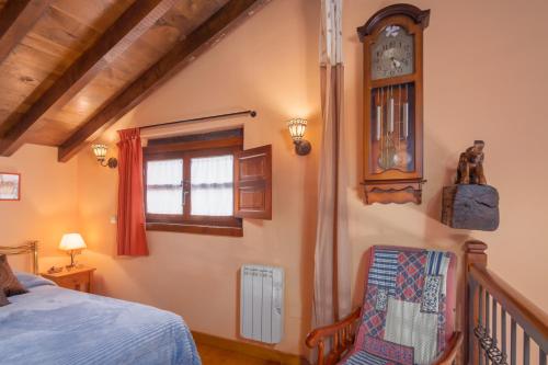桑提亚纳德玛El Cierruco的卧室配有一张床,墙上挂着一个钟