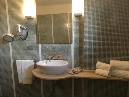 科斯蒂廖莱达斯蒂酒店＆蒙法拉托酒店的浴室配有盥洗盆、镜子和毛巾