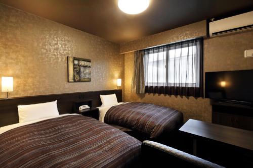 伊势市伊势路线酒店的酒店客房设有两张床和电视。