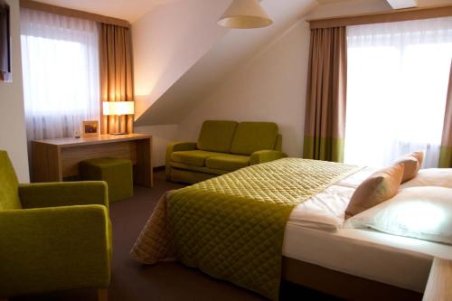 塔贝斯多夫阿尔特斯客尔乡村旅馆的配有一张床和一把椅子的酒店客房