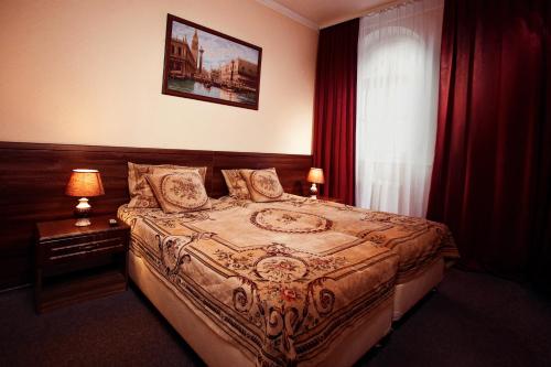 基兹洛沃茨克米沙塔度假村的一间卧室配有床和红色窗帘的窗户