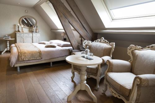 隆德泽尔登贝尔赫酒店的卧室配有一张床和一张桌子及椅子