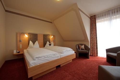 贡岑豪森阿德博恩兰德加特酒店的卧室配有一张白色大床