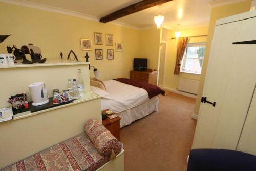 马基特德雷顿Ternhill Farm House - 5 Star Guest Accommodation with optional award winning breakfast的一间卧室配有一张床和一个沙发