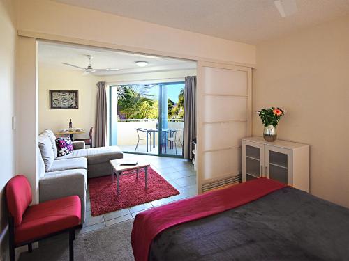 努萨维尔桑迪肖尔斯努萨河酒店的一间卧室设有一张床和一间客厅。