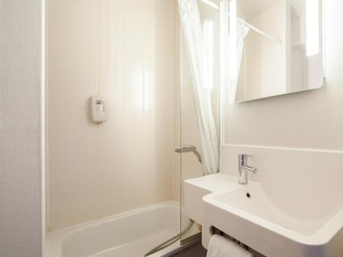 克雷伊B&B HOTEL Creil Chantilly的白色的浴室设有水槽和淋浴。