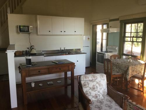 蒂阿瓦穆图老学校乡村民宿的厨房配有水槽和桌椅