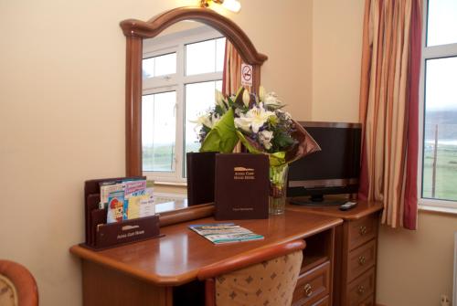 基尔Achill Cliff House Hotel & Restaurant的一张桌子,上面有镜子和花瓶