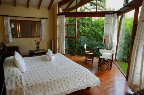 比加瓜特诺里奥旅舍的卧室配有白色的床和桌椅