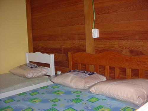 加罗帕巴Tranquilidade na Praia da Gamboa的卧室设有两张木墙