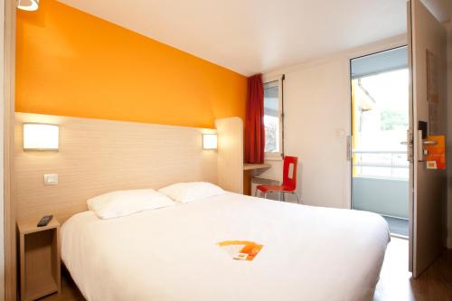 雷泽南南斯 - 赫泽机场普瑞米尔经典酒店的酒店客房设有一张白色大床和一个窗户。
