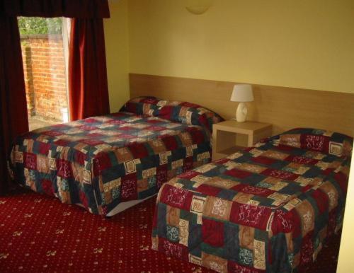 北安普敦朗廷酒店的酒店客房设有两张床和窗户。