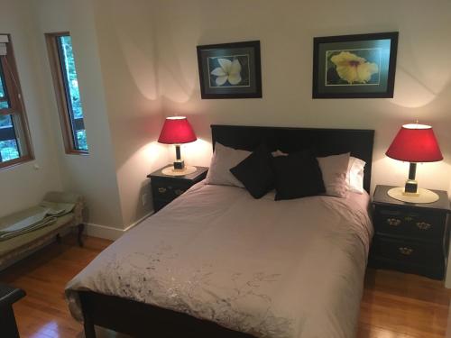 夸利库姆海滩Ashling Cottage的一间卧室配有一张带两盏灯的床。