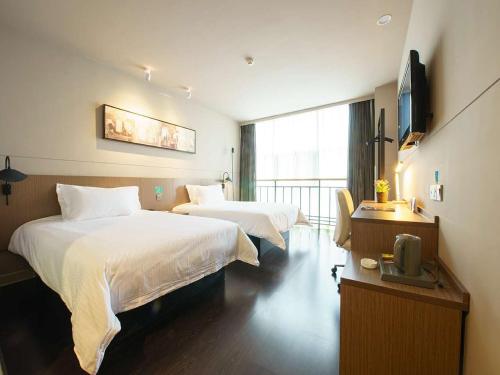 西安锦江之星品尚西安南二环高新酒店的酒店客房设有两张床和电视。