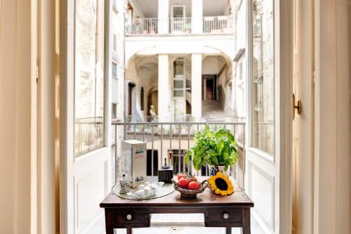 那不勒斯Arthouse Lady Marys Tribunali Luxury Suite的阳台上的桌子上放着一碗水果