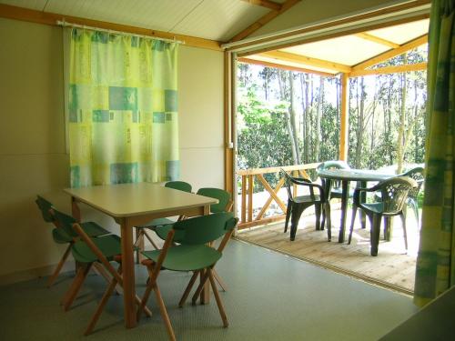 库迪列罗Camping L´Amuravela的配有桌椅和门廊的房间