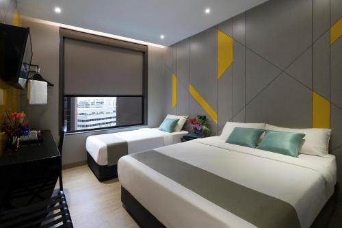 Hotel Mi Bencoolen客房内的一张或多张床位