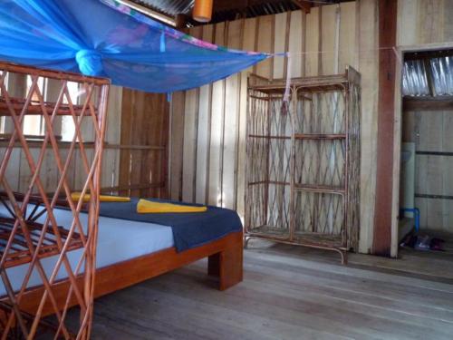 Phumĭ Kâng KéngKoh Thmei Resort的一间卧室配有一张带蓝色天蓬的双层床