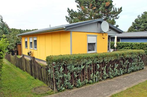 韦森贝格Ferienhaus Klein Quassow SEE 8771的前面有栅栏的黄色房子