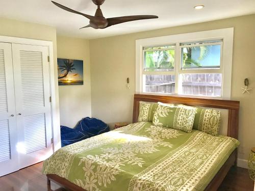 凯卢阿Beautiful Guest House Kailua Beach的一间卧室配有一张床和吊扇