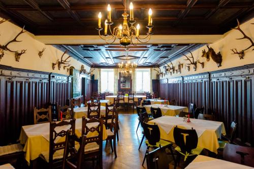 Obdach戈洛各霍乡村旅馆的一间带桌椅和吊灯的用餐室