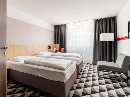 acom-Hotel Vienna客房内的一张或多张床位