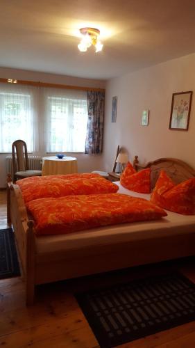 拉姆绍Haus Mühlgraben的一间卧室配有一张带橙色毯子的大床