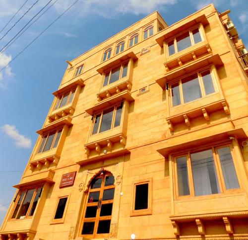 斋沙默尔秘密之家成人酒店的一座高大的黄色建筑,有许多窗户