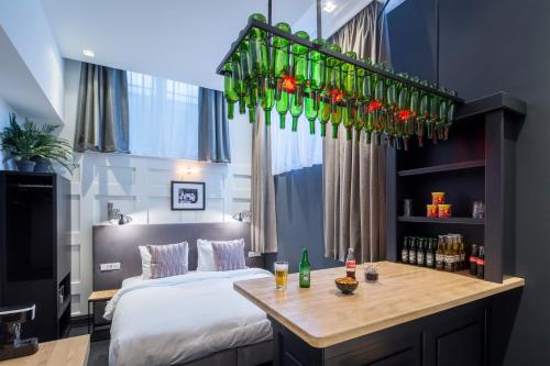 阿姆斯特丹高地之家酒店的一间卧室配有一张床和一张桌子,上面有饮料