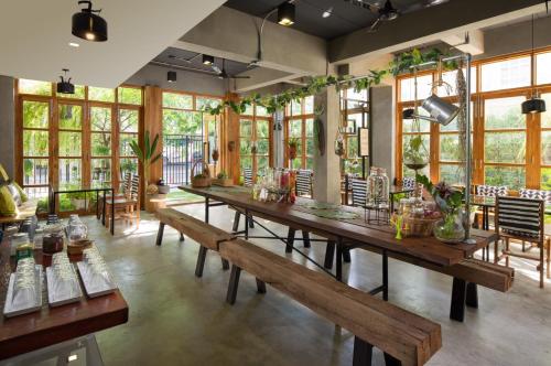 曼谷曼谷汉莎府住宿加早餐旅馆的大房间设有长木桌和长凳